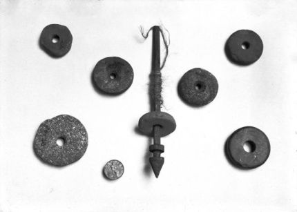 Prehistoric Spindle Whorls, Dundrum Sand Hills - a view laid out, of a spindle and Whorls and an old penny for scale. (Location: Northern Ireland; County Down; Dundrum). Date: circa early 1900s